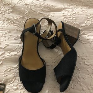 Black low heels with a buckle.